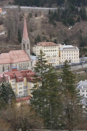 a group of buildings with a church and a tower at Hotel Lindenhof in Bad Gastein
