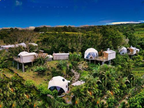 an aerial view of a farm with tents and trees at Bubble Dome Village in Saint-Joseph