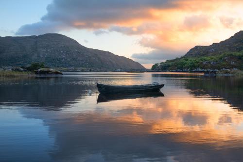 a boat sitting in the middle of a lake at Hotel Killarney in Killarney