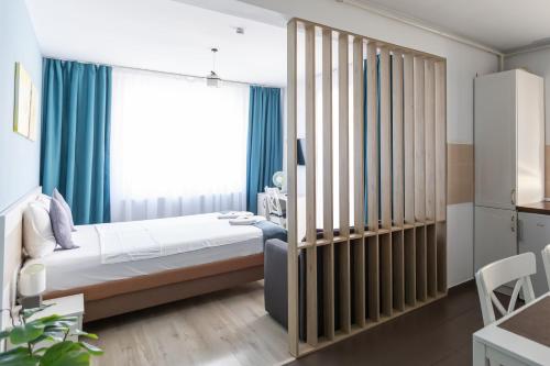 a bedroom with a bed and a large window at Montana Studios in Braşov