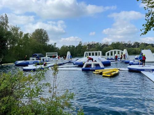 a group of inflatables are lined up in the water at The Lakeside 55 Caravan 8 Bert with Hot Tub at Tattershall Lakes in Tattershall