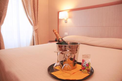 a bottle of champagne in a bucket on a bed at Hotel Alpi Resort in Turin