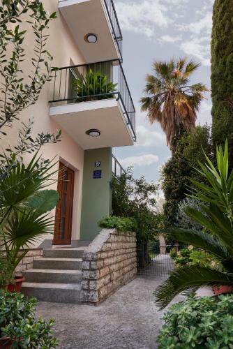 a building with a staircase and a balcony at Palmaja in Kaštela