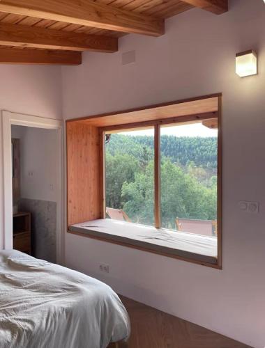 a bedroom with a large window with a view at San Bartolomé Etxea 2 in Ea