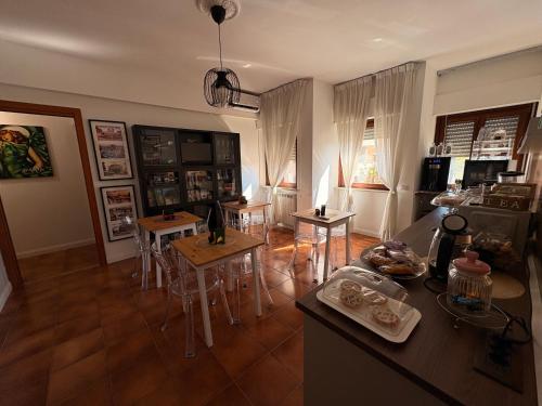 a kitchen and dining room with tables and chairs at Aniene Home Roma in Rome