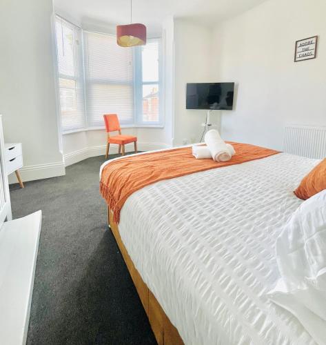 a bedroom with a large bed and a chair at Francis Avenue in Portsmouth