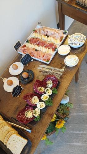 a wooden table with appetizers and food on it at Hotel Villa Cuserina in Cannobio
