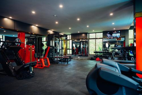 a gym with treadmills and machines in a room at Green Mountain Hotel in Arusha