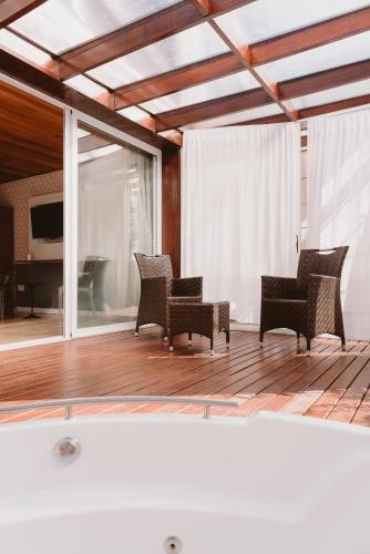 a living room with chairs and a piano at Puerto Dijama Hotel Boutique in Carmelo