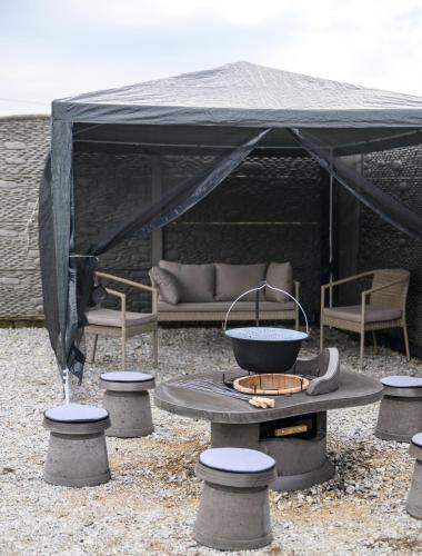 a black tent with a table and some chairs at Pezsgő Vendégház in Demjén