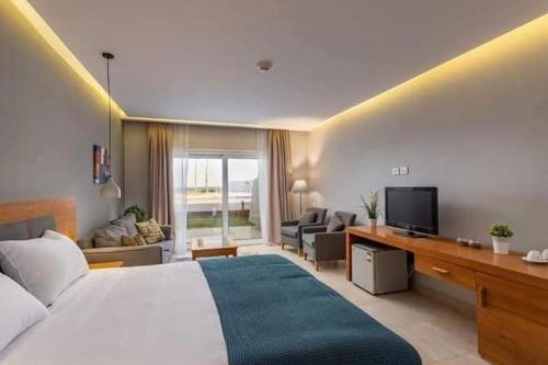a bedroom with a large bed and a living room at Miral Resort in Ain Sokhna