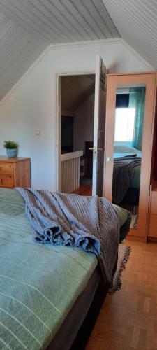 a bedroom with a bed and a room with a window at 'Bij de buren' in Norra Skoga