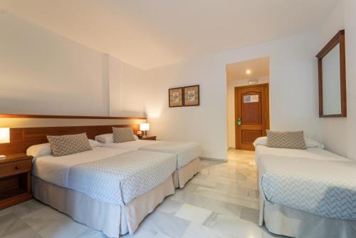 a bedroom with two beds in a room at Hotel Piedra Paloma by Croma in Estepona