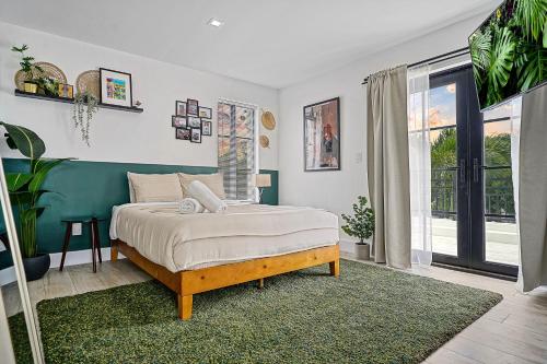 a bedroom with a bed and a large window at Villa Verde Miami in Miami
