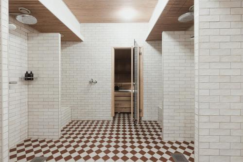 a bathroom with a shower with a checkered floor at Home Hotel Jugend in Helsinki