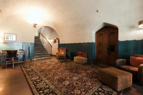 a living room with a staircase and a couch at Home Hotel Jugend in Helsinki