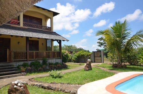 a house with a swimming pool in front of it at La Maison Soleil in Trou dʼ Eau Douce
