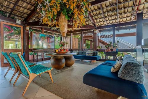 a living room with a couch and chairs and a table at Hotel Praia do Sol in Ilhéus