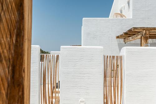 a group of white buildings with a blue sky in the background at plaka riviera villa in Naxos Chora