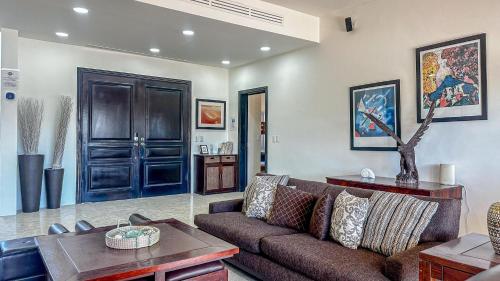 a living room with a couch and a table at A Wave FROM IT ALL in Las Conchas
