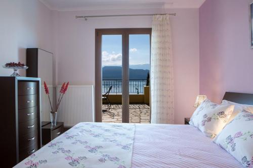 a bedroom with a bed and a view of the ocean at Buena Vista Villa - Amazing sea view in Lygia