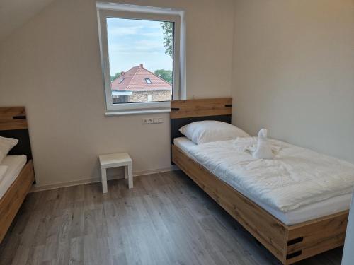 a small bedroom with a bed and a window at Wohnung 2 in Haselünne