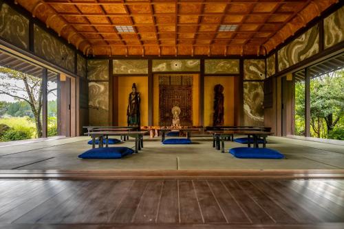 an inside view of a room with tables at Cultural Resort Meihodo in Matoishi