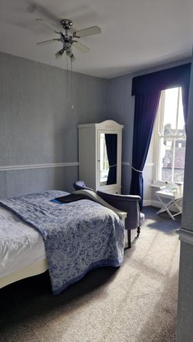 a bedroom with a bed and a ceiling fan at New Hall Bank in Bowness-on-Windermere