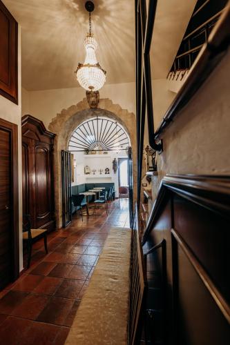 a hallway with a dining room and a dining table at Palazzo Giunta - Porta Marina Ortigia in Siracusa