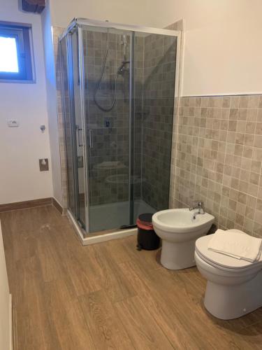 a bathroom with a shower and a toilet and a sink at Poncinvs Residence in Bergamo