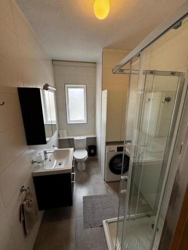 a bathroom with a toilet and a sink and a shower at Sunny Retreat - Families, Couples & Digital Nomads in Is-Sellum