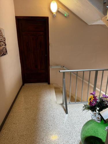 a stairway with a door and a vase of flowers at Sunny Retreat - Families, Couples & Digital Nomads in Is-Sellum