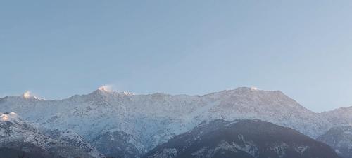 a group of mountains with snow on them at Mountain Heaven Mcleodganj in Dharmsala