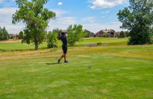 a man taking a picture of a golf ball at Flying Horse Resort & Club in Colorado Springs