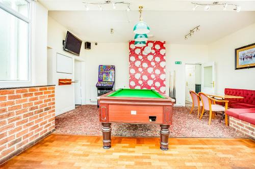 a living room with a pool table in it at The Village Inn, Murton Seaham in Murton