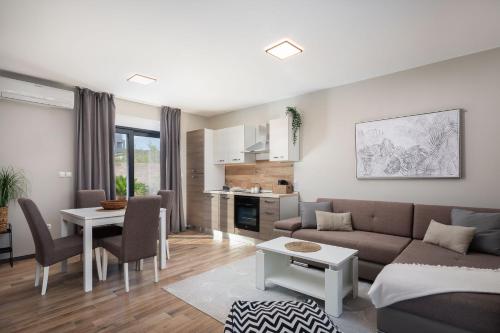 a living room with a couch and a table at Villa Emma on Island Pag for 14 persons with sea view, wellness & pool heating in Pag