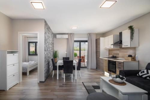 a living room with a kitchen and a dining room at Villa Emma on Island Pag for 14 persons with sea view, wellness & pool heating in Pag