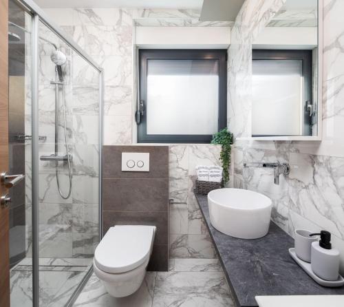 a bathroom with a toilet and a sink and a shower at Villa Emma on Island Pag for 14 persons with sea view, wellness & pool heating in Pag