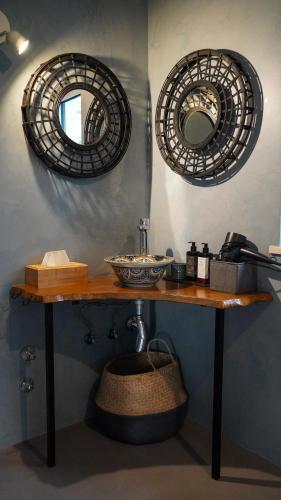 a bathroom with two mirrors and a table with a sink at Monte da Urze Aljezur - Agroturismo in Aljezur