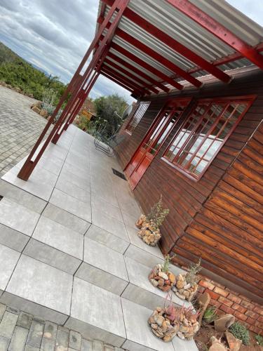 a building with potted plants in front of it at Klein Karoo Game Lodge in Oudtshoorn