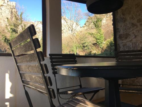 a table and chairs in a room with a window at Mymoustiers in Moustiers-Sainte-Marie