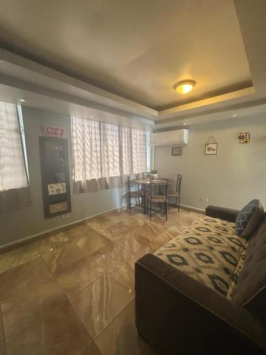 a living room with a couch and a tv and a table at IVT Condo in San Juan