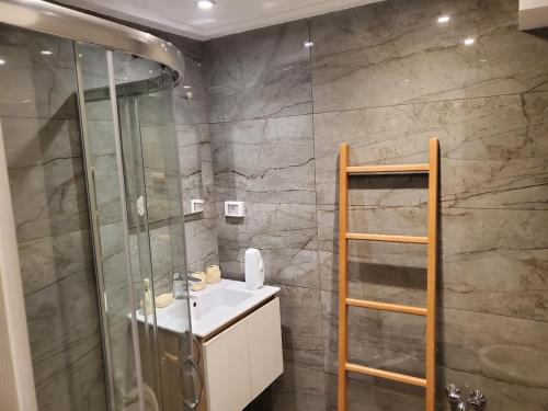a bathroom with a sink and a glass shower at luxury marsa beach 2 in La Marsa