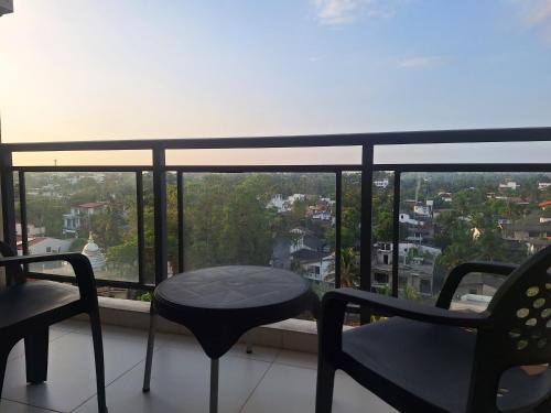 a balcony with two chairs and a table and a view at Urban living at Fairway in Battaramulla