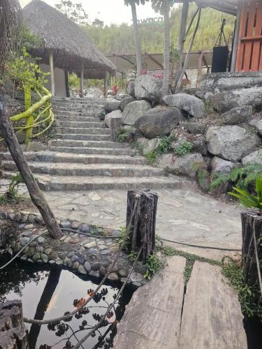 a set of stone stairs with a rock wall at cabañas zona verde tayrona in Santa Marta