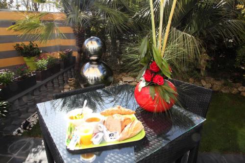 a table with a plate of food on it at Hotel Ibis Budget Nice Palais Nikaia in Nice