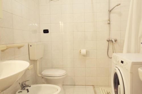 a bathroom with a toilet and a sink and a shower at Casa vacanze LuGi by Apulia home in Torre San Giovanni Ugento