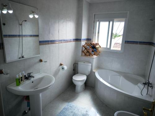 a bathroom with a tub and a toilet and a sink at Bungalow Malibu Complex Doa Pepa- Rojales in Ciudad Quesada