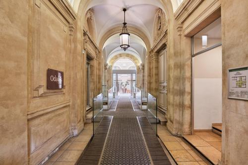 a hallway in a building with a long corridor at Appart Hotel Odalys City Montpellier Les Occitanes in Montpellier