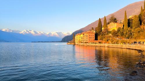 a large body of water with buildings and mountains at On the Lake in Bellano